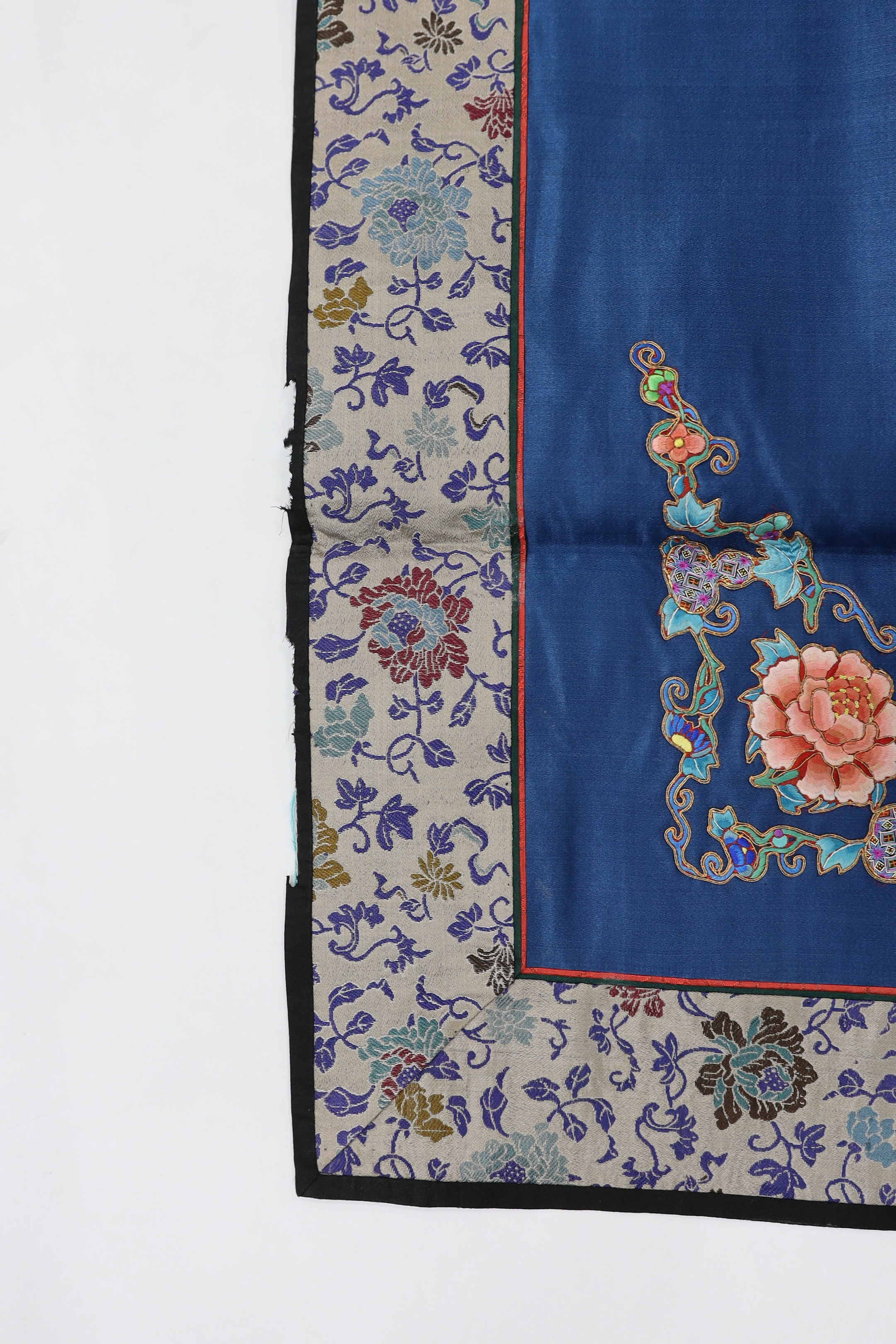 Five Chinese embroidered mats with polychrome silk embroidery using Beijing knot stitch, together with a large square blue silk cover with silk embroidered spot motifs and gold thread work, all items bordered with silk b